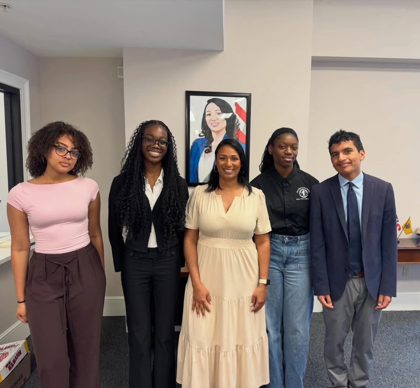 Assemblywoman Carmen Morales posing with four people in an office